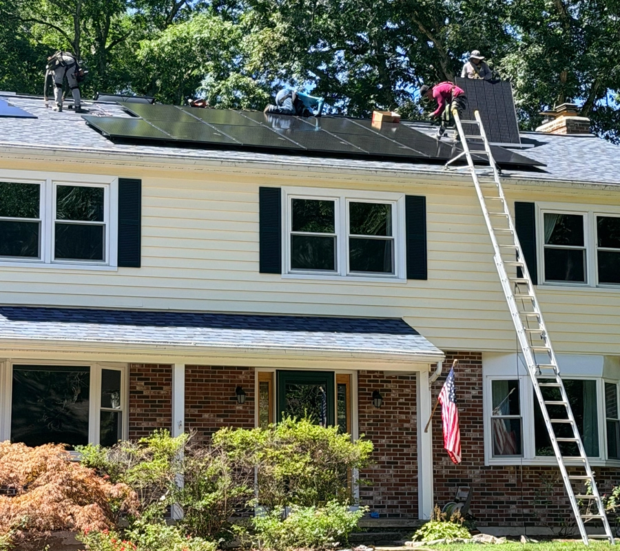 Installer over Roof Installing Solar Panels