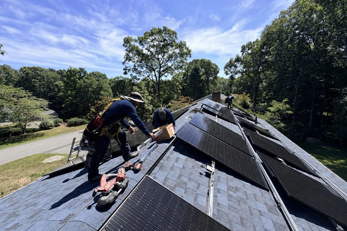 Solar installers reinstalling solar panels